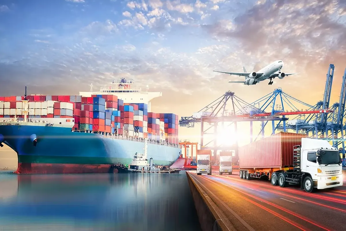A container port with ships, cranes and freight vehicles at dusk